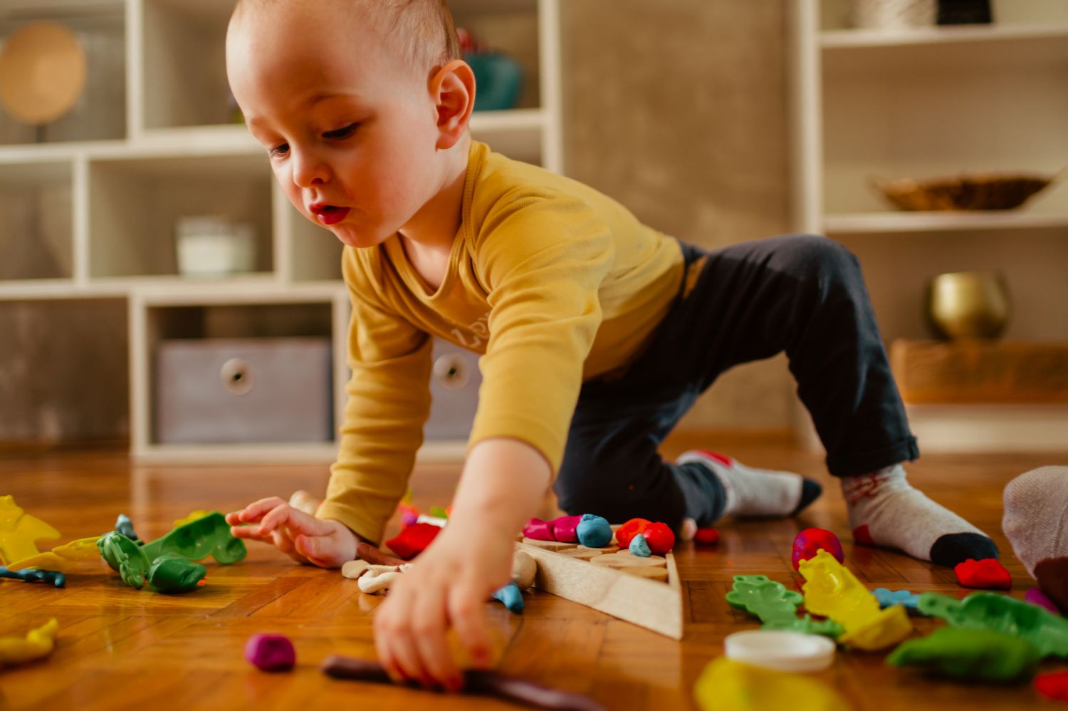toddler playing with clay